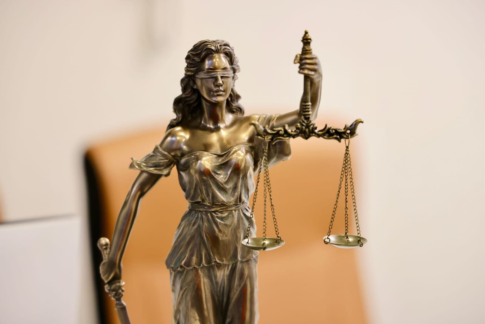 Close-up of Lady Justice statue holding scales, symbolizing justice and fairness